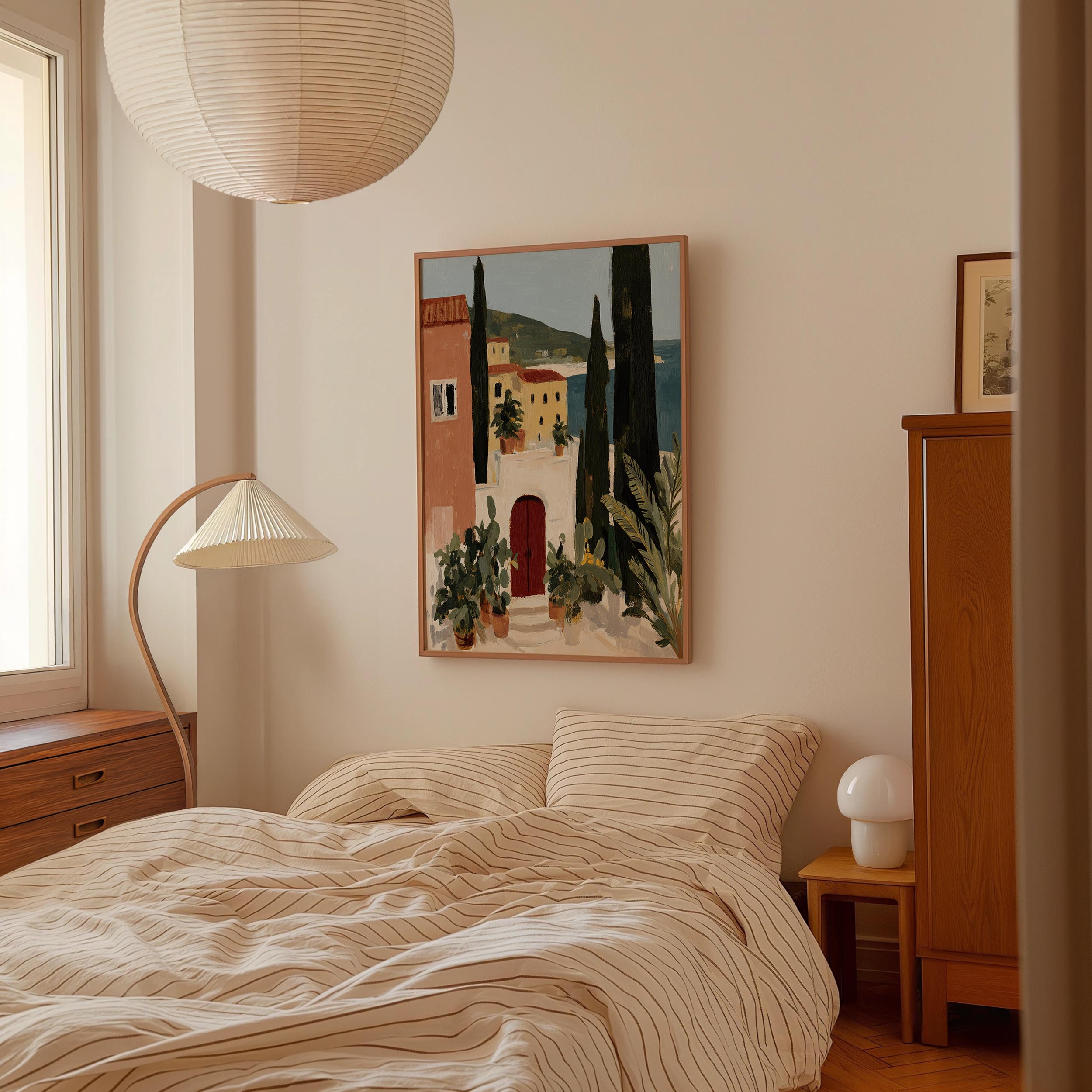 a cozy bedroom with a large bed, a wooden dresser, and a painting of a picturesque town hanging on the wall.