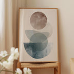 a framed abstract art print displayed on a wooden stand.