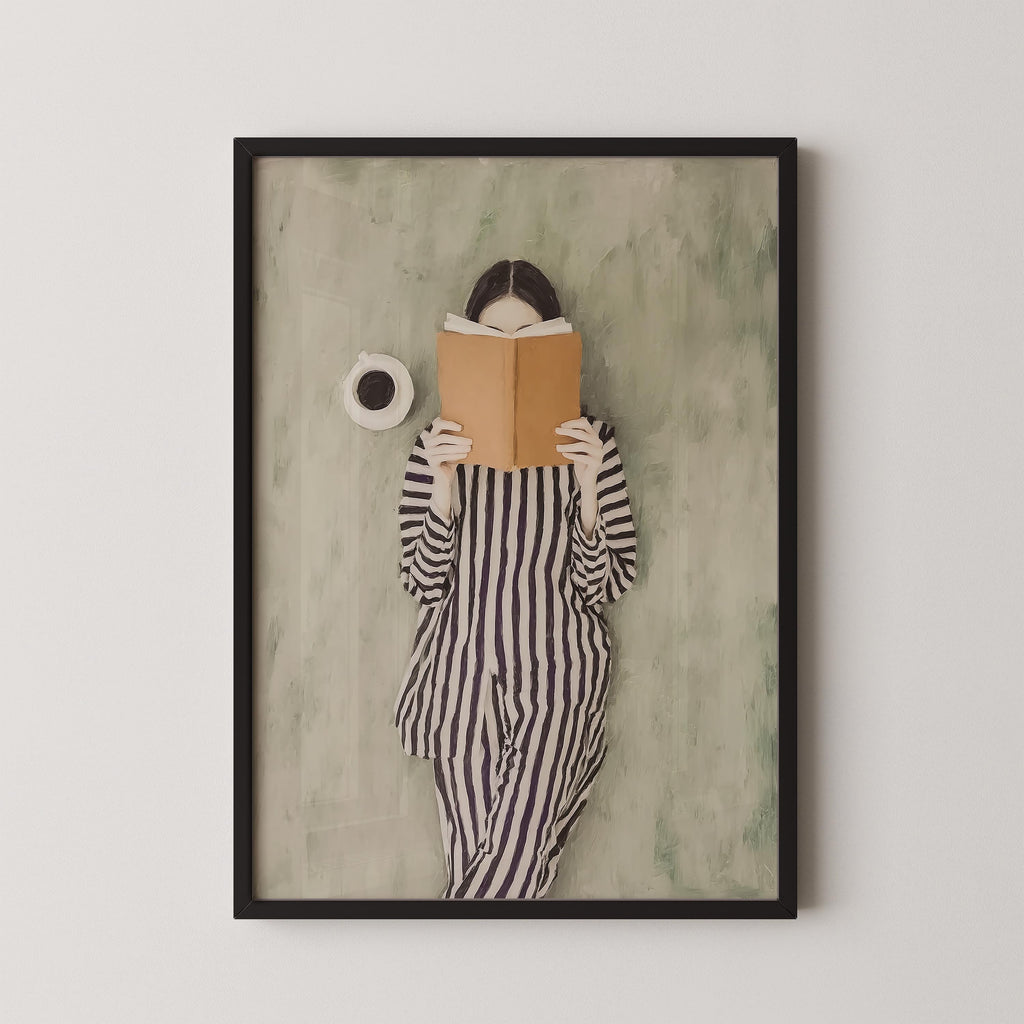 A framed image of a person in a striped outfit reading a book.