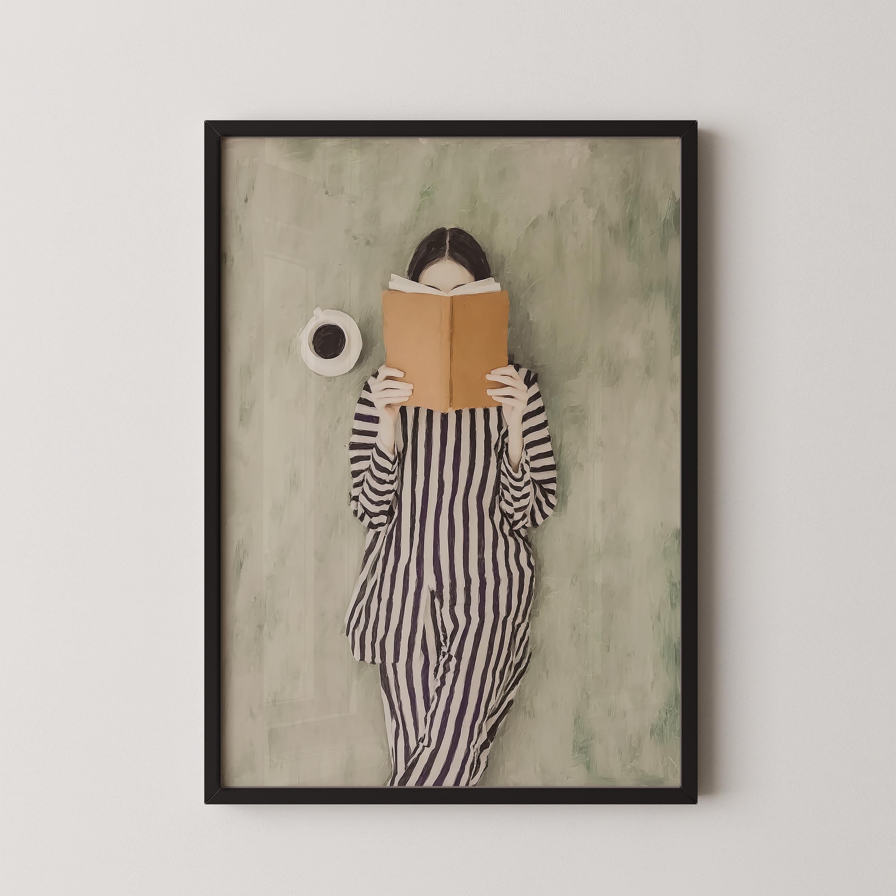A framed image of a person in a striped outfit reading a book.