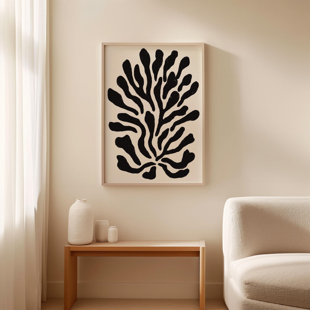 a minimalist living room with a large abstract black and white artwork hanging on the wall above a wooden table with three small white vases on it.