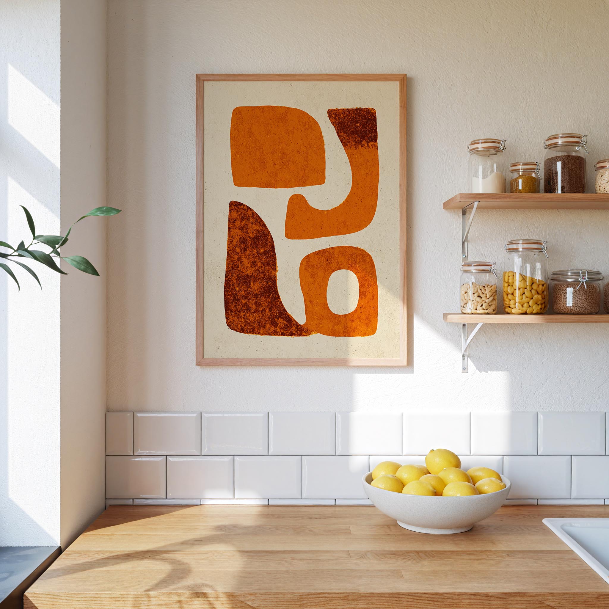 a kitchen counter with a bowl of lemons, a framed abstract art piece, and shelves displaying various jars and containers.