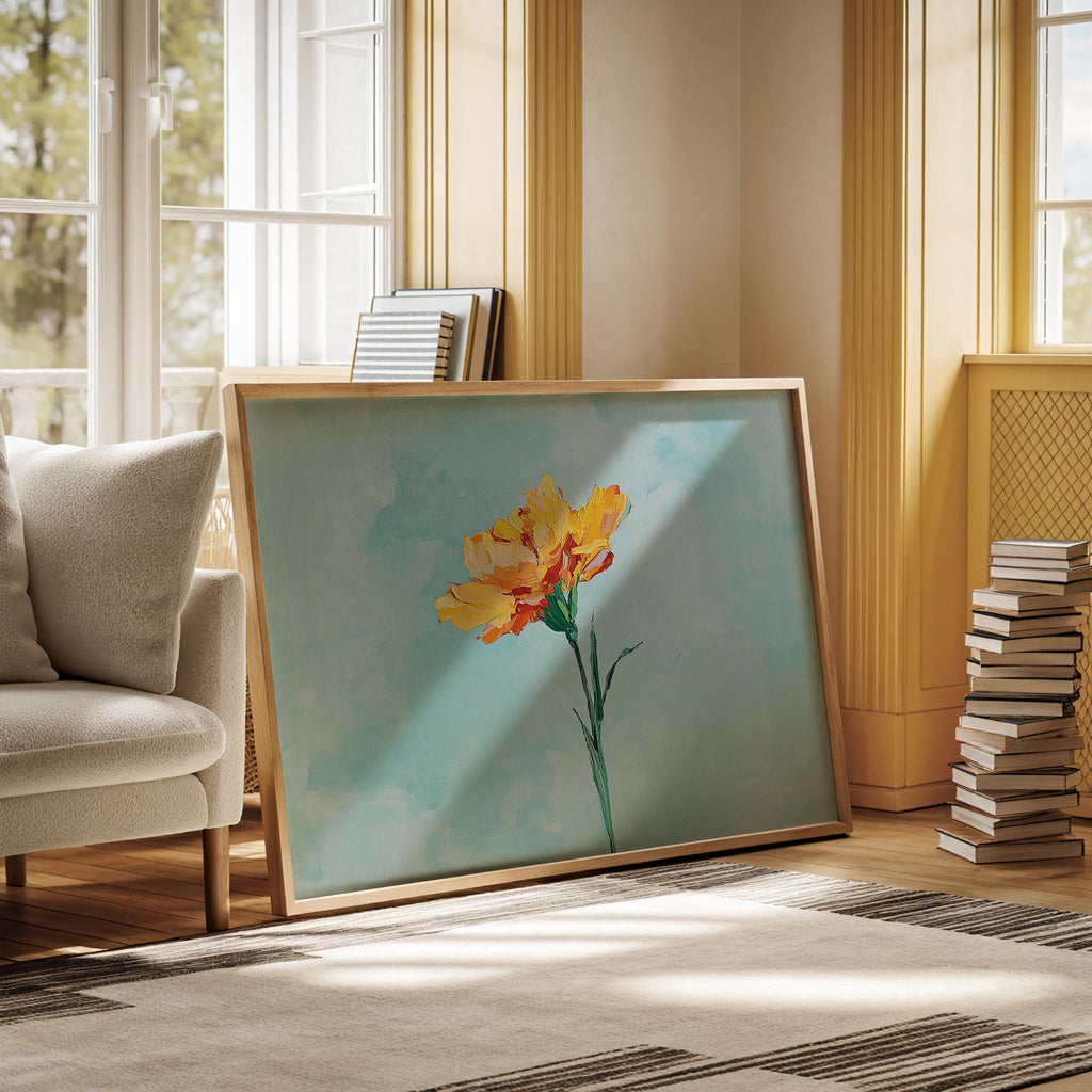 a large painting of a yellow flower on a blue background, placed on a rug in a room with a window and a stack of books.