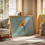 a large painting of a yellow flower on a blue background, placed on a rug in a room with a window and a stack of books.