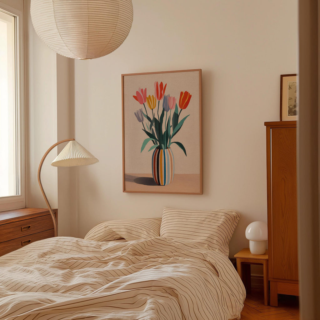 a cozy bedroom with a bed, a lamp, and a framed artwork of colorful tulips on the wall.