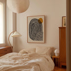a bedroom with a bed, a lamp, and a framed abstract artwork on the wall.