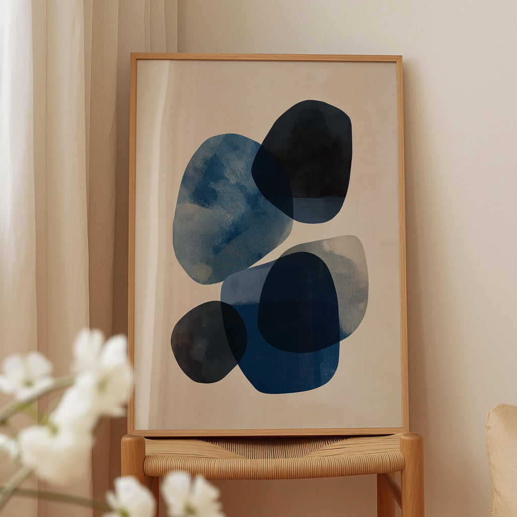 a framed abstract art piece with a blue and white color scheme, displayed on a wooden stand.