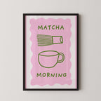 The image is a framed poster with a pink background and a green cup and whisk illustration. The text "MATCHA MORNING" is displayed above the illustration.