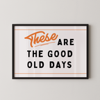 a framed poster with the text "These are the good old days" in a bold, orange font.