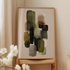 a wooden chair with a framed abstract painting hanging on it. The painting consists of various shades of green and brown, creating a visually striking composition.