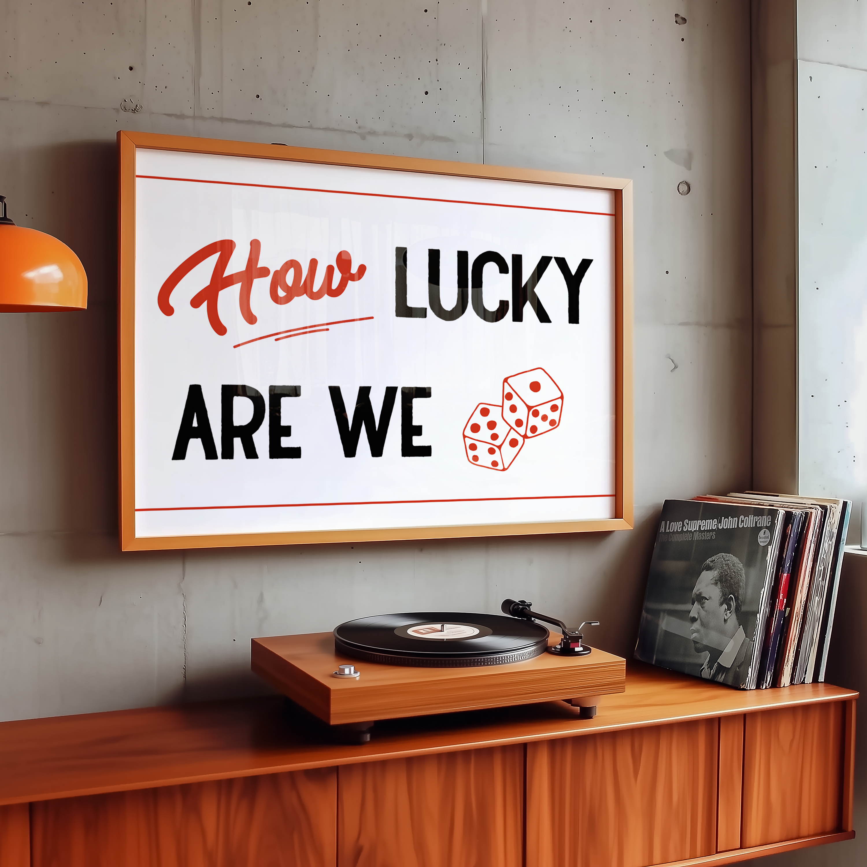 A framed poster with the text "How LUCKY ARE WE" hangs on a wall above a wooden record player and a collection of vinyl records.