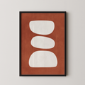 a framed abstract art piece with a brown background and three white shapes arranged in a row.