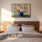 a bedroom with a wooden headboard and a bed with striped bedding. Above the bed is a framed painting of a vase with colorful flowers.