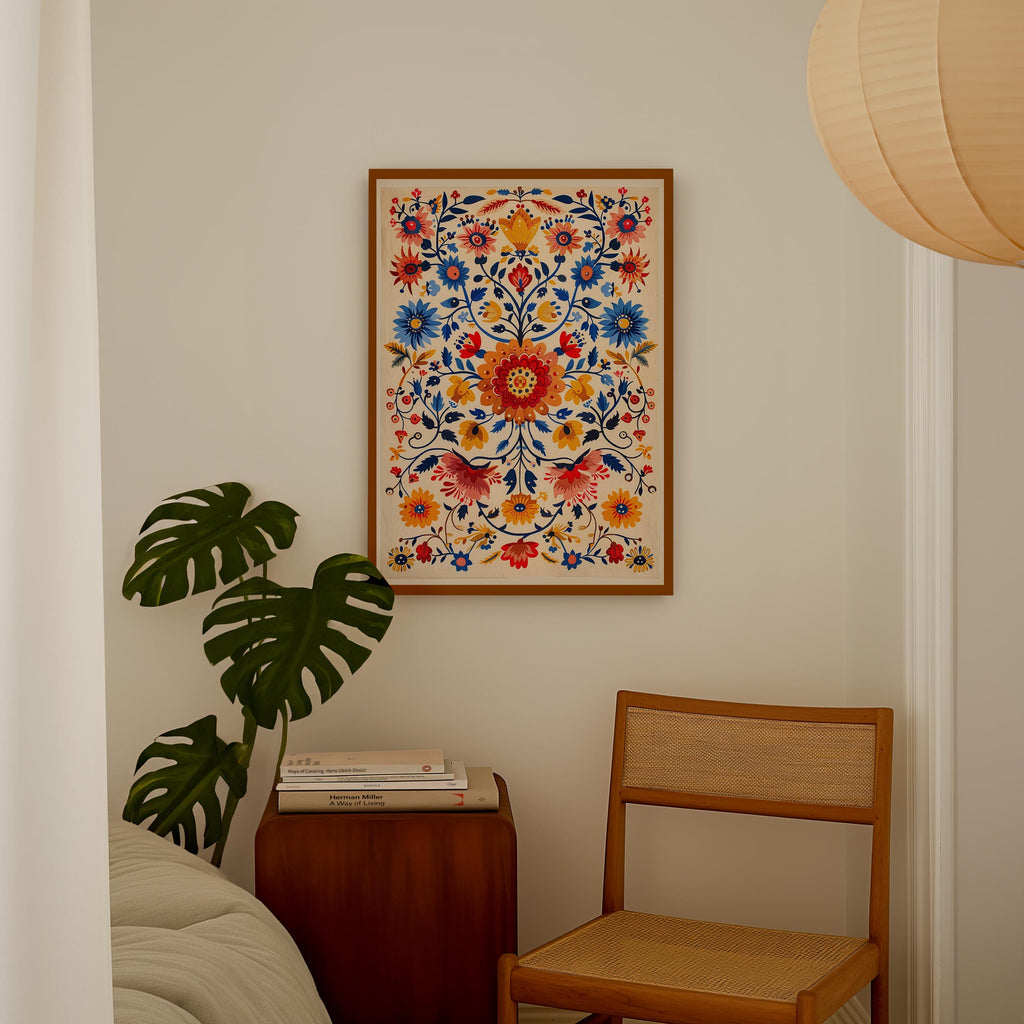 a cozy corner of a room with a wooden chair, a wooden side table, and a framed colorful floral print hanging on the wall.
