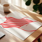a white paper with a red and white striped design, placed on a wooden surface.