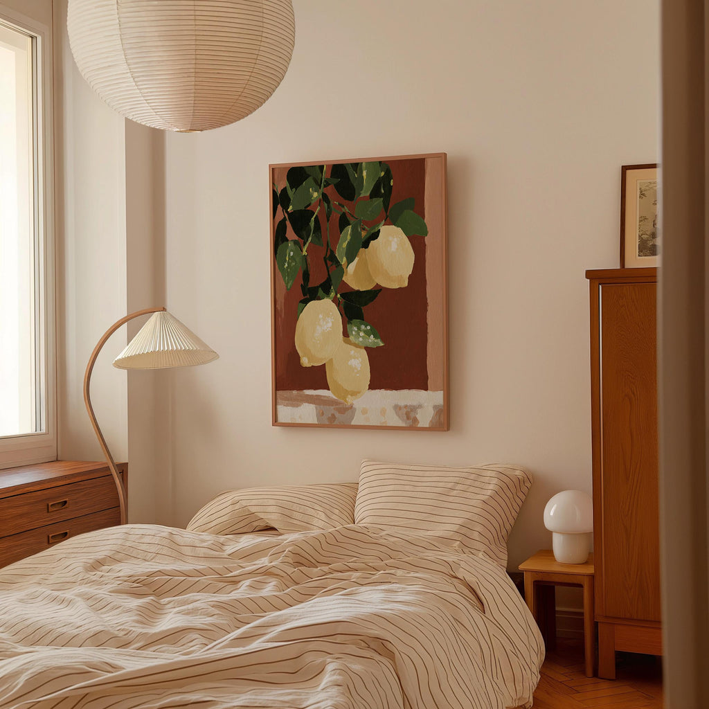 a cozy bedroom with a bed, a lamp, and a painting of lemons hanging on the wall.