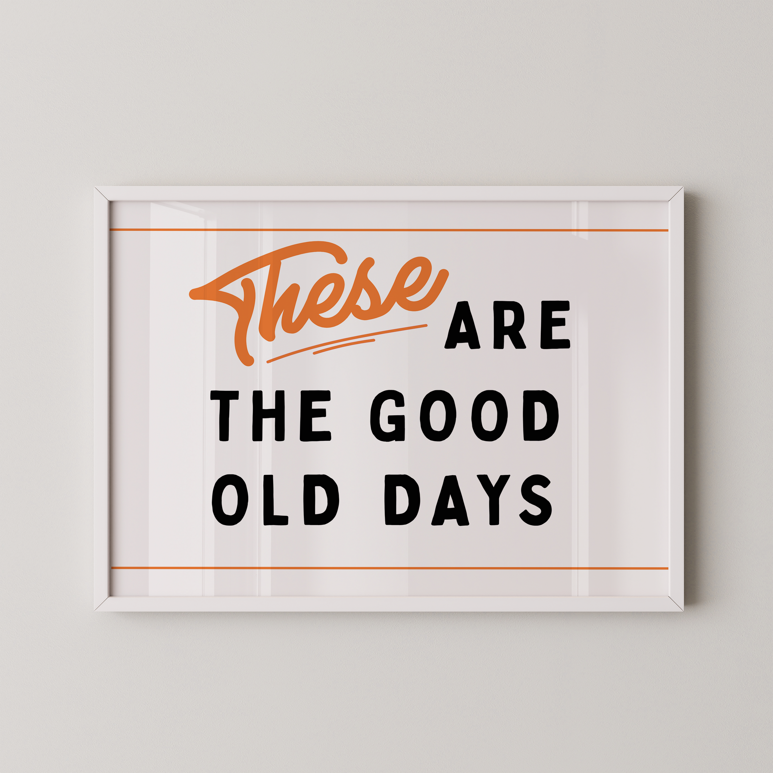a framed poster with the text "These are the good old days" in a bold, orange font.