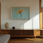 a modern living room with a wooden cabinet, a framed painting of a yellow flower, and a white vase on a shelf.