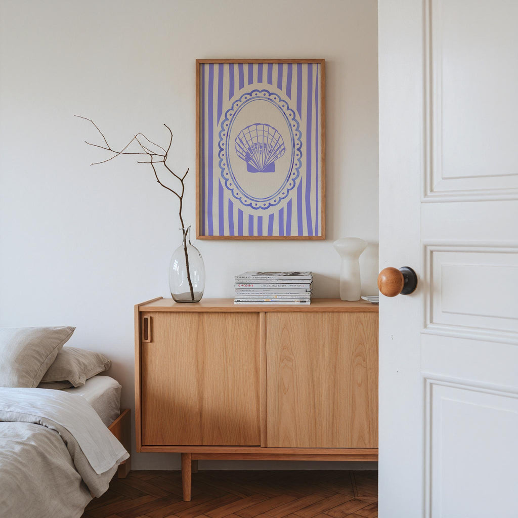 a cozy bedroom scene with a bed, a wooden dresser, and a framed artwork on the wall.