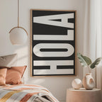 a bedroom with a bed, a framed sign, and decorative elements such as a potted plant and a vase.
