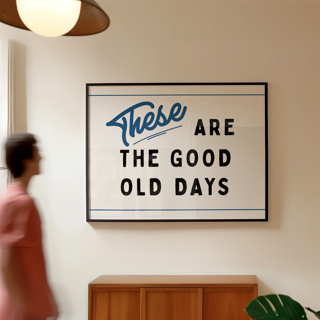 a framed sign with the text "These are the good old days" hanging on a wall.