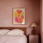 a bedroom with a bed, a lamp, and a framed artwork on the wall.
