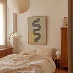 a cozy bedroom with a large bed, a lamp, and a framed abstract artwork on the wall.