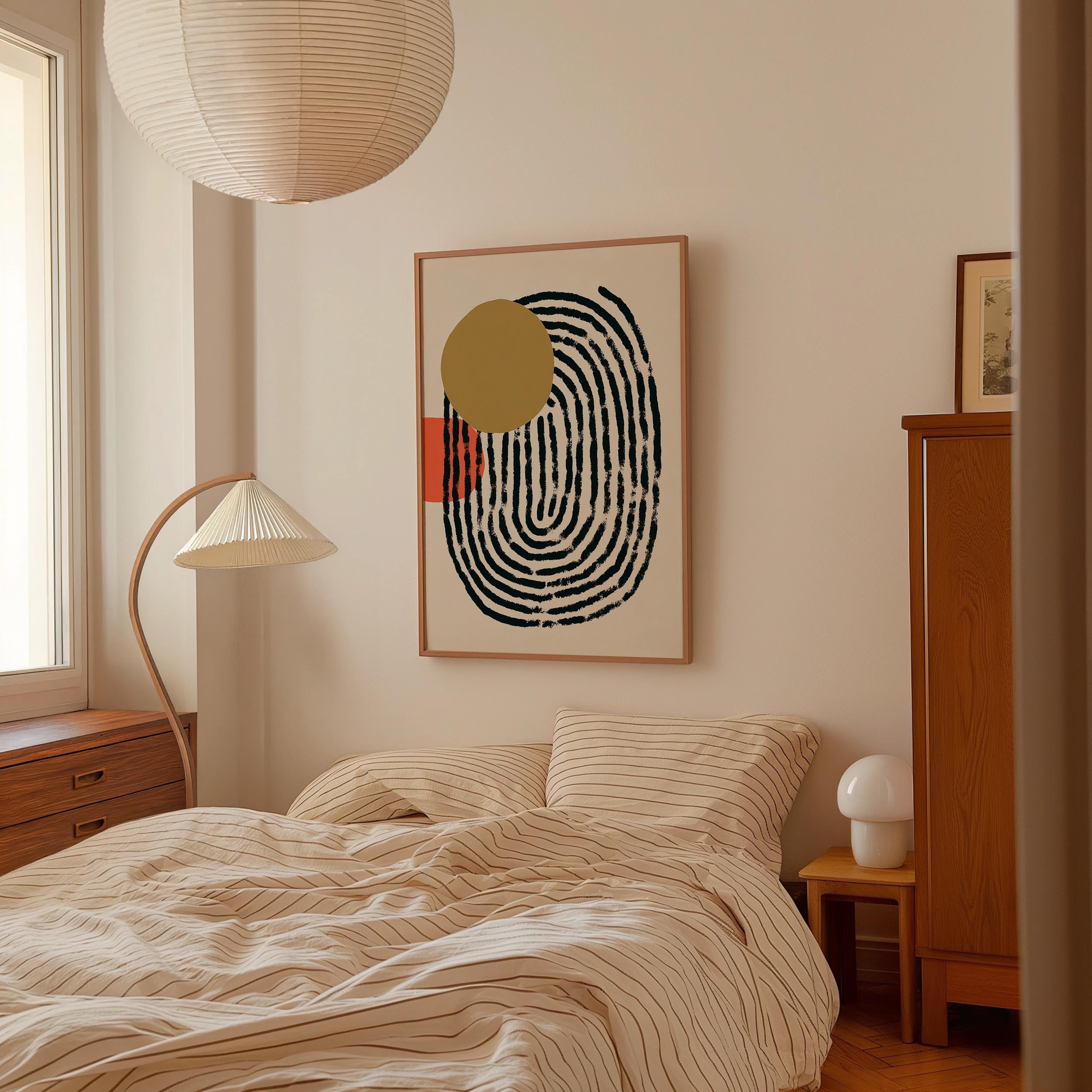 a bedroom with a bed, a lamp, and a framed abstract artwork on the wall.