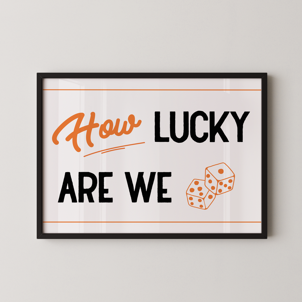 a framed poster with the text "How LUCKY ARE WE" and two dice graphics.
