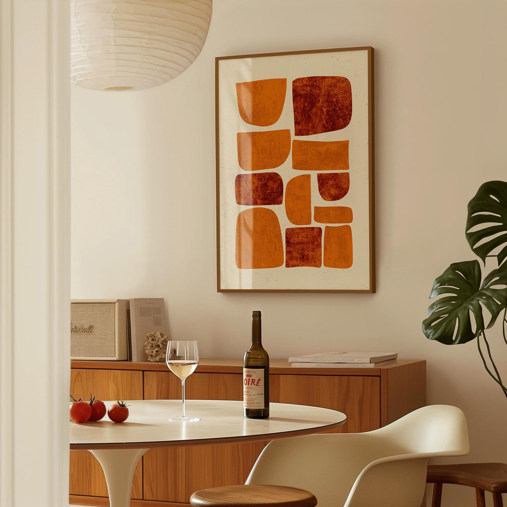 a dining area with a table, a bottle of wine, and a framed abstract art piece on the wall.