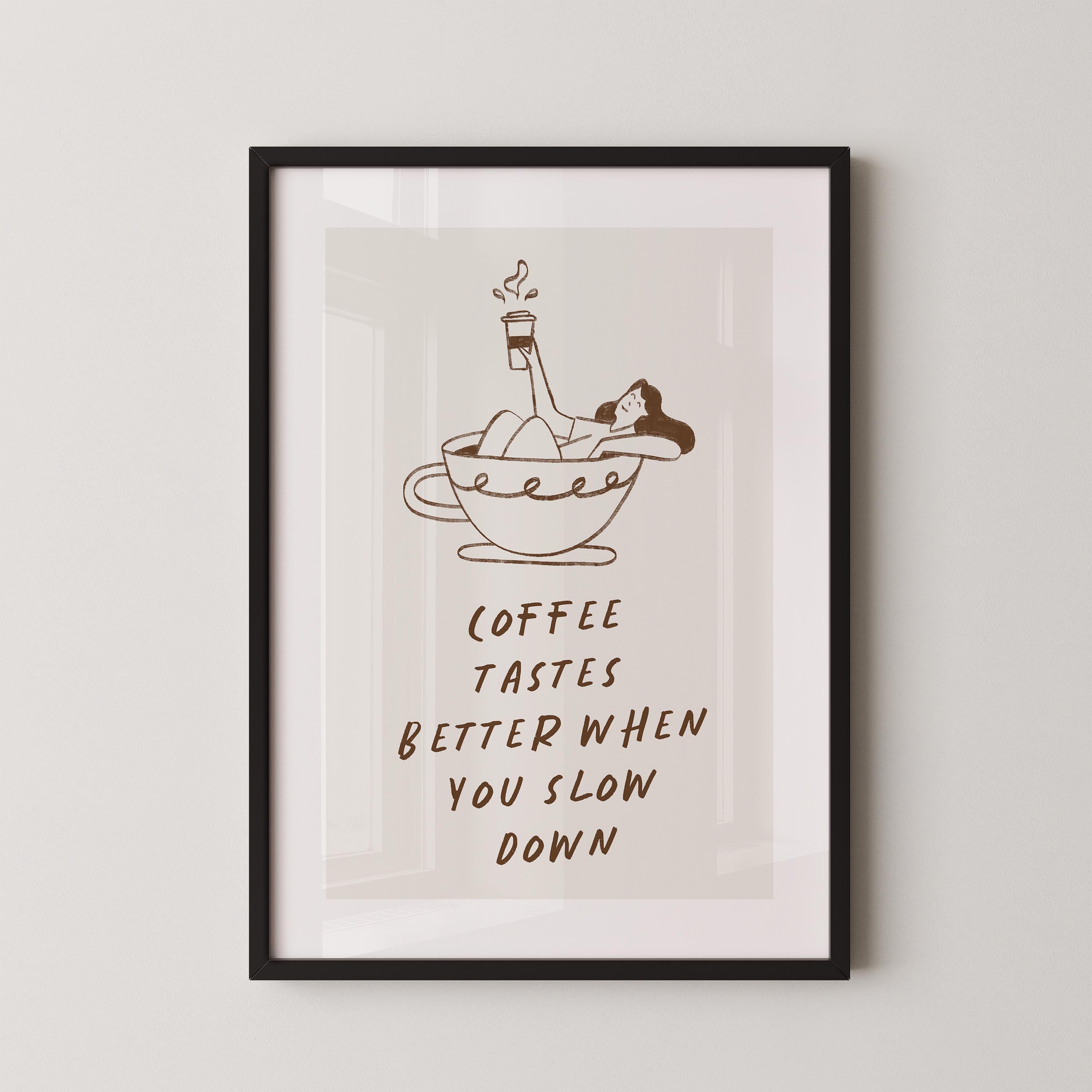 a framed poster with a cartoon illustration of a woman relaxing in a cup of coffee, accompanied by the text "Coffee tastes better when you slow down".