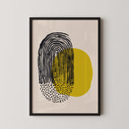 The image is a framed abstract art piece featuring a black and yellow design with a large black stripe and smaller yellow circles.