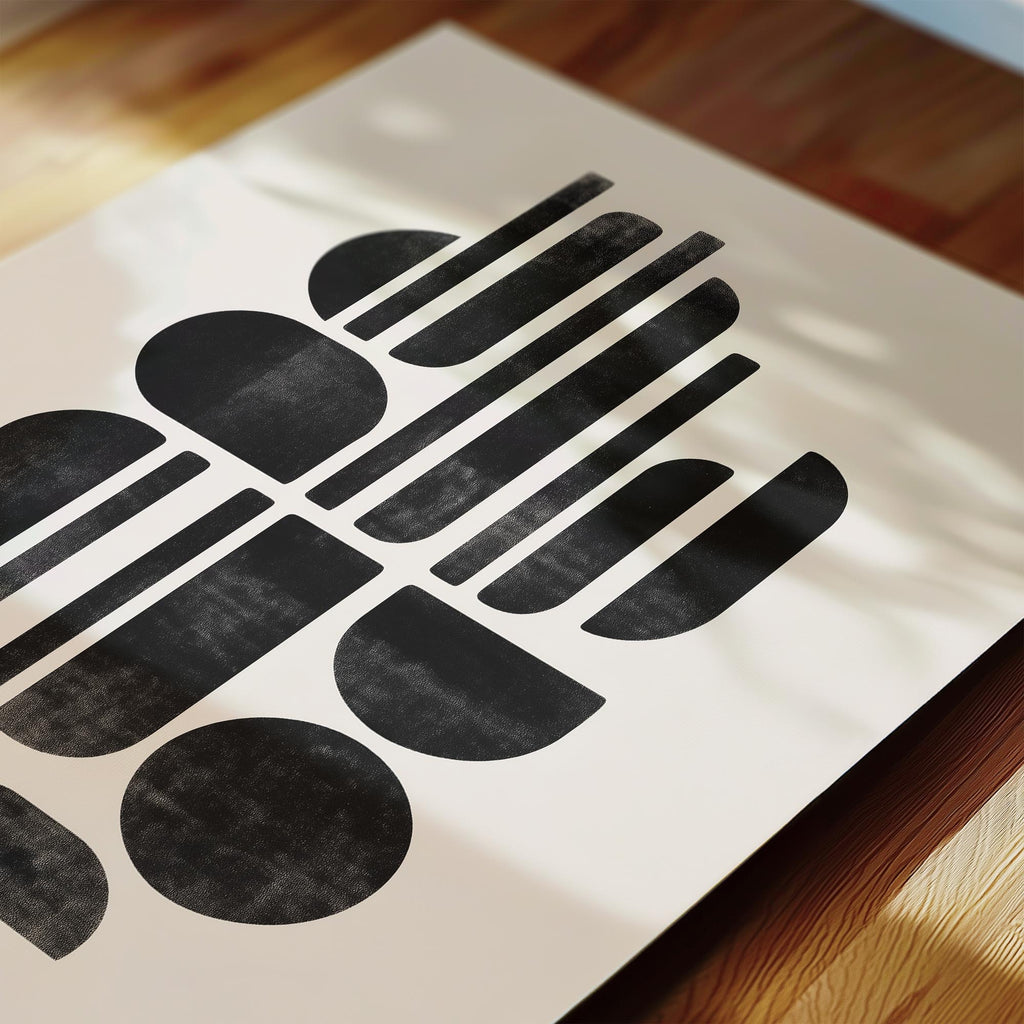 a close-up view of a white paper with a striking black geometric design composed of various shapes and lines.