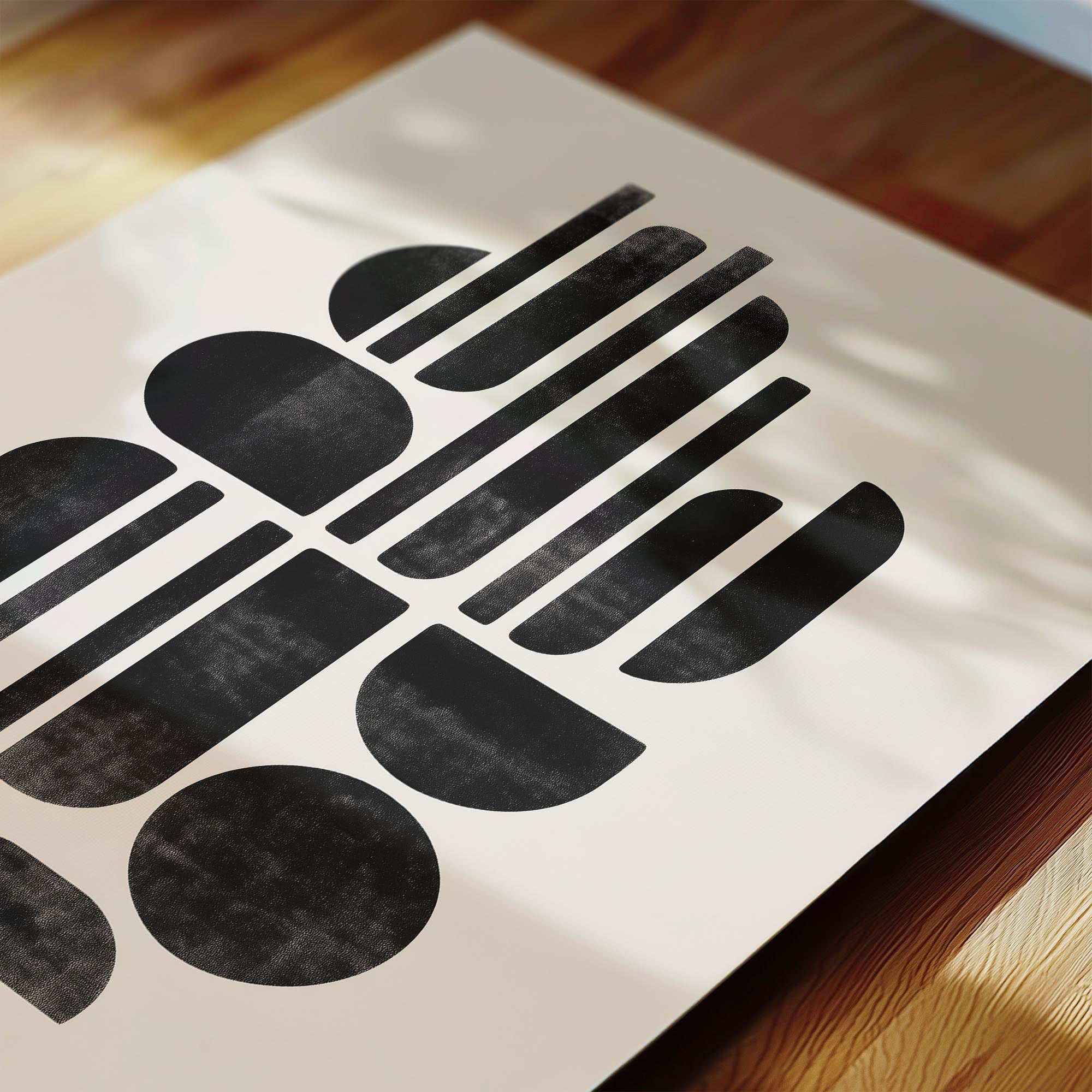 a close-up view of a white paper with a striking black geometric design composed of various shapes and lines.