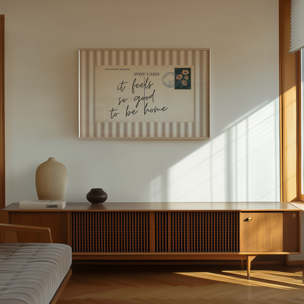 a minimalist living room with a wooden cabinet, a bed, and a framed poster on the wall.
