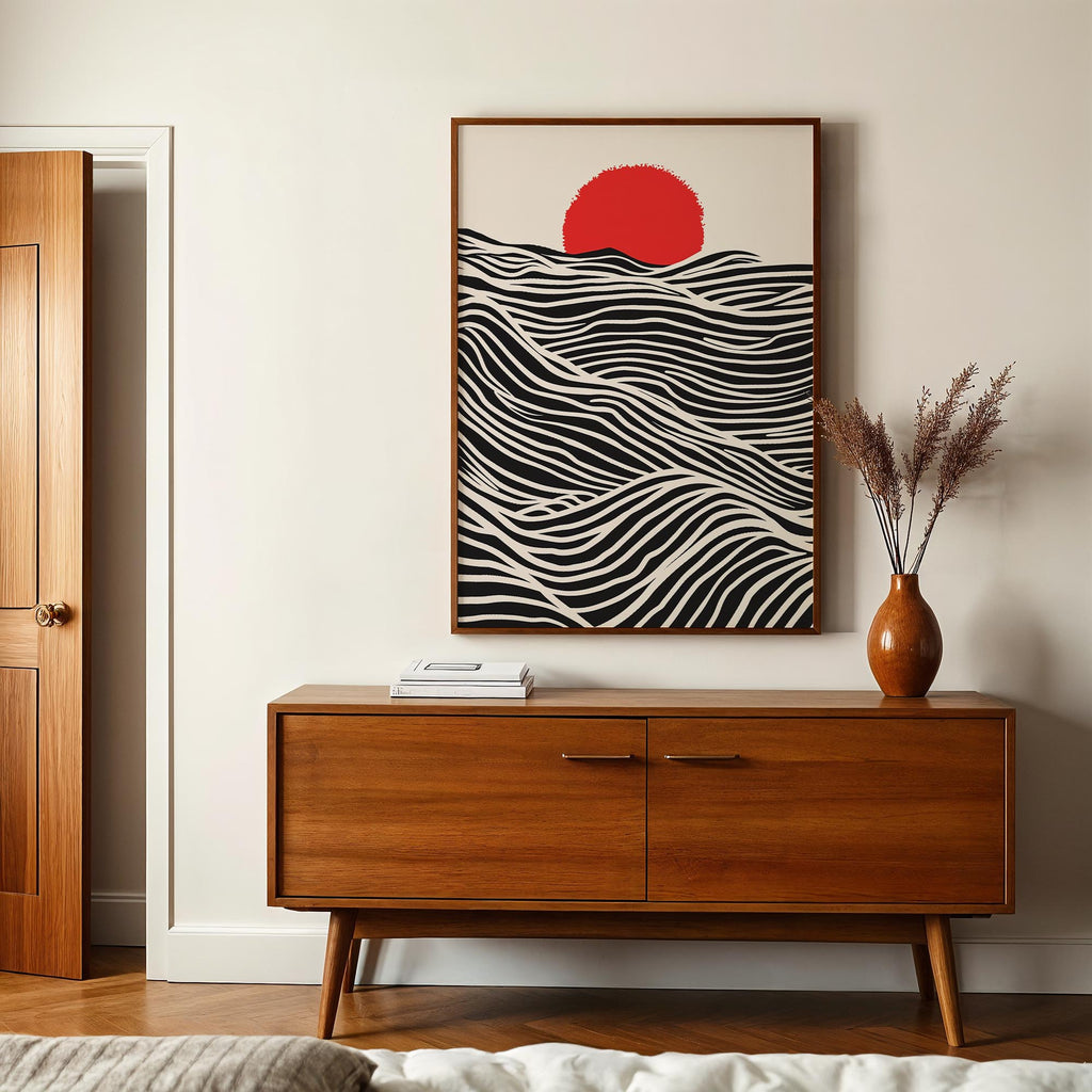 a wooden cabinet with a framed abstract artwork hanging above it, and a vase of dried flowers on a table below the cabinet.