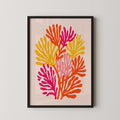 The image is a framed artwork depicting a vibrant, abstract floral design with various shades of orange, pink, and yellow.
