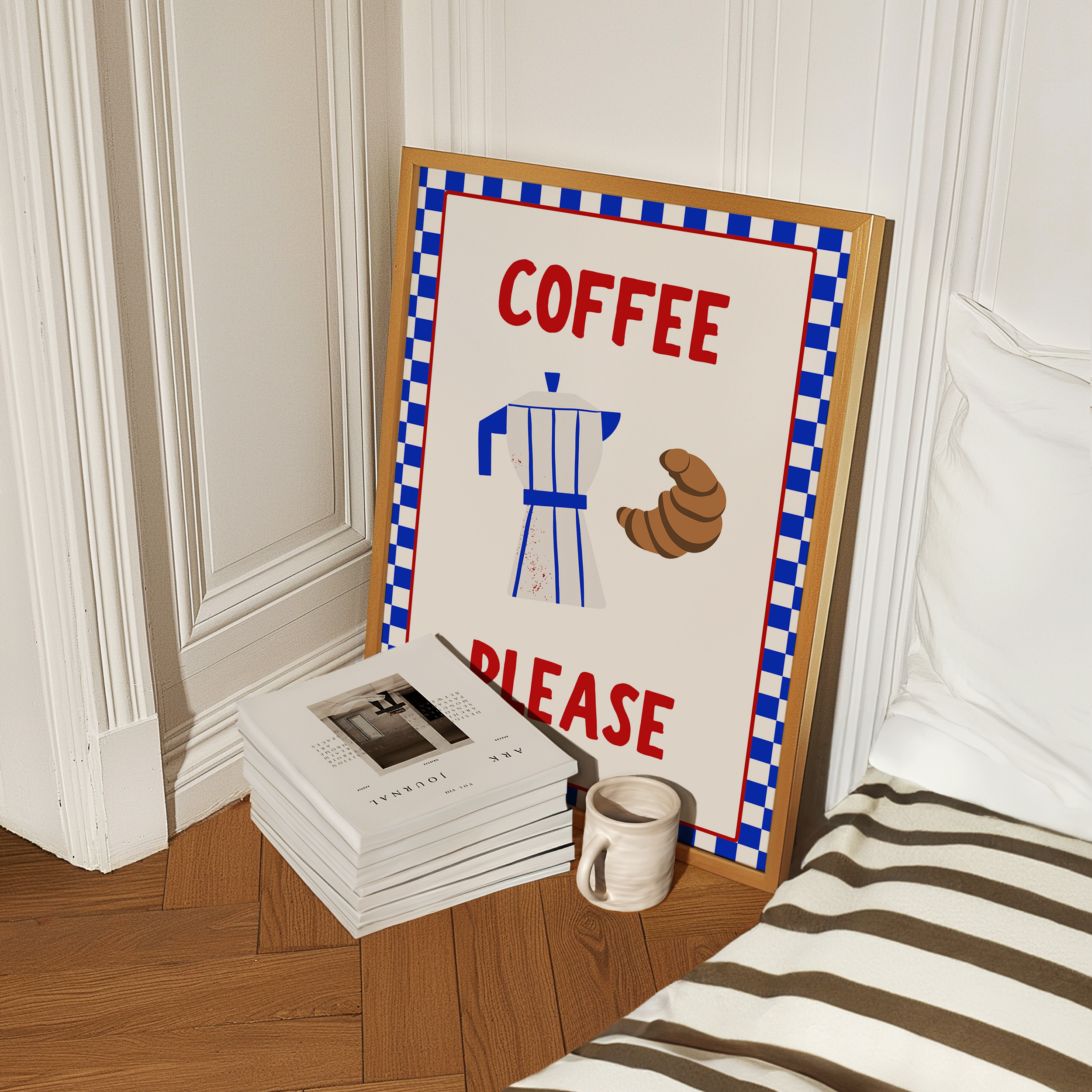 a framed poster with a coffee-themed design, including a coffee maker and a croissant, placed on a wooden floor next to a stack of books and a coffee mug.