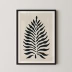 a framed print of a stylized leaf design in black and white.