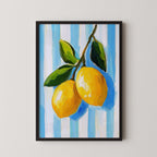 A framed painting depicting a branch with two bright yellow lemons against a blue and white striped background.
