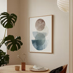 a minimalist dining area with a wooden table, a vase with flowers, and a framed abstract art piece hanging on the wall.