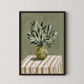 A framed illustration of a vase filled with green leaves and branches, placed on a striped tablecloth.