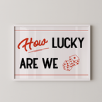 a framed poster with the text "How LUCKY ARE WE" and two dice graphics.