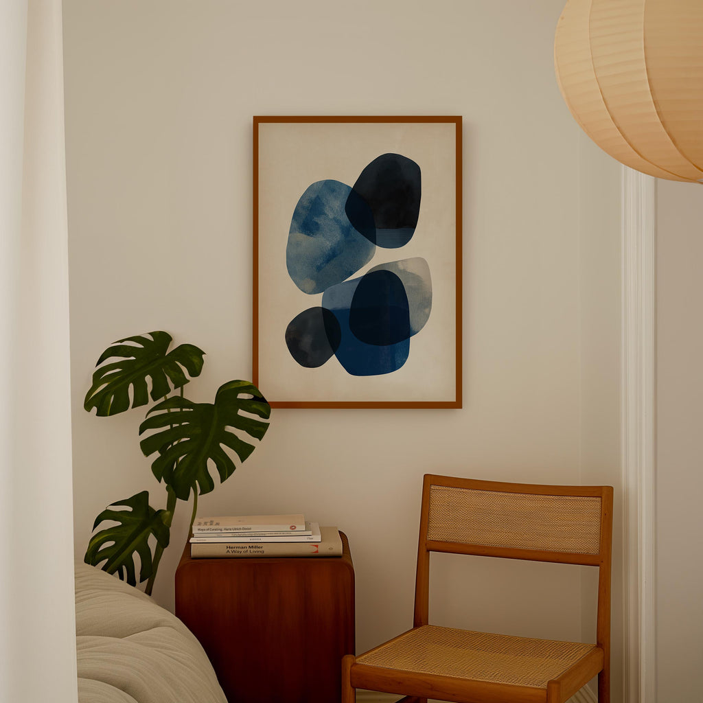 a cozy corner of a room with a wooden chair, a wooden side table, and a framed abstract art piece hanging on the wall.