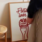 a person standing next to a framed poster with a red design of a fork and pasta.