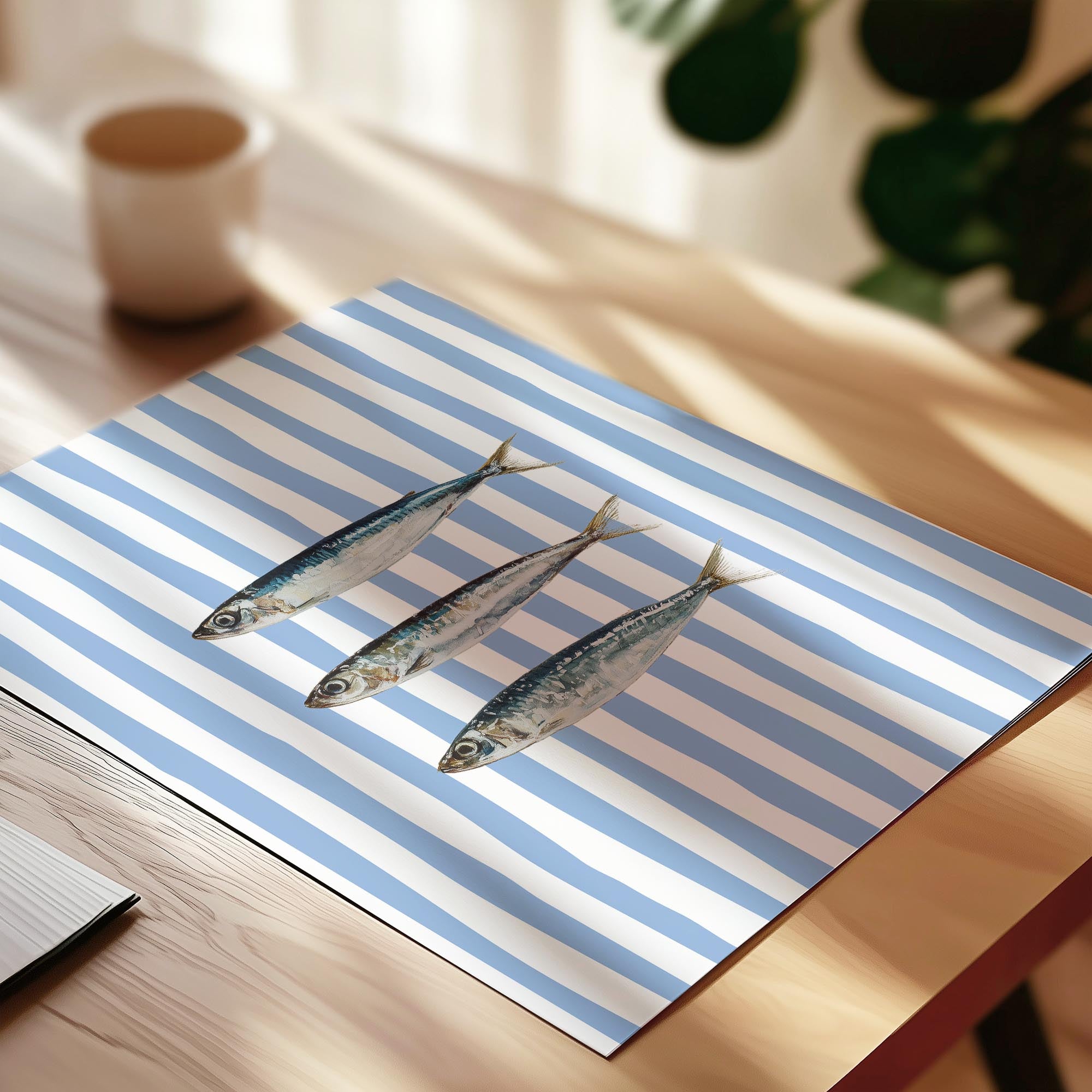 three small fish on a blue and white striped tablecloth.
