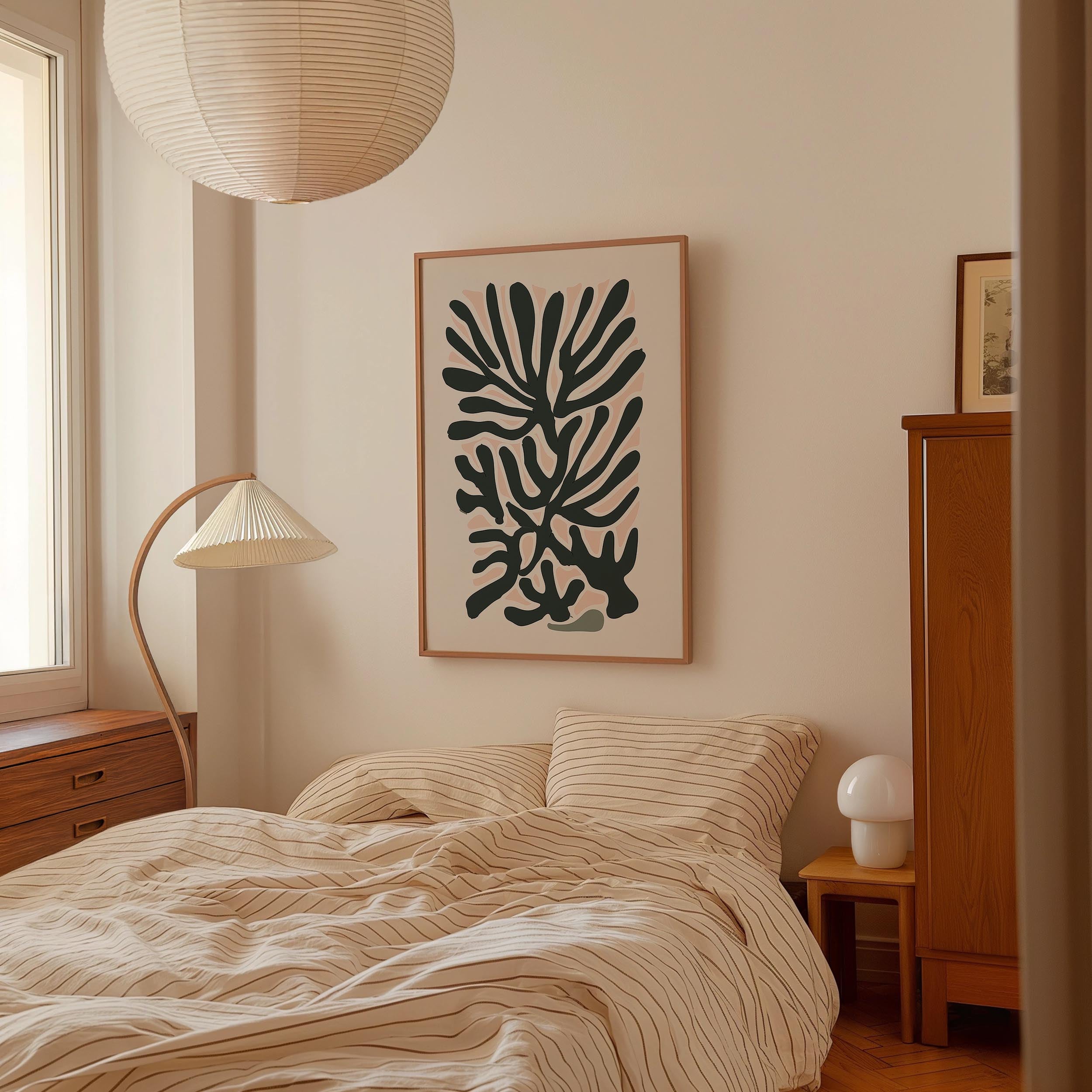 a bedroom with a bed, a lamp, and a framed abstract art piece on the wall.