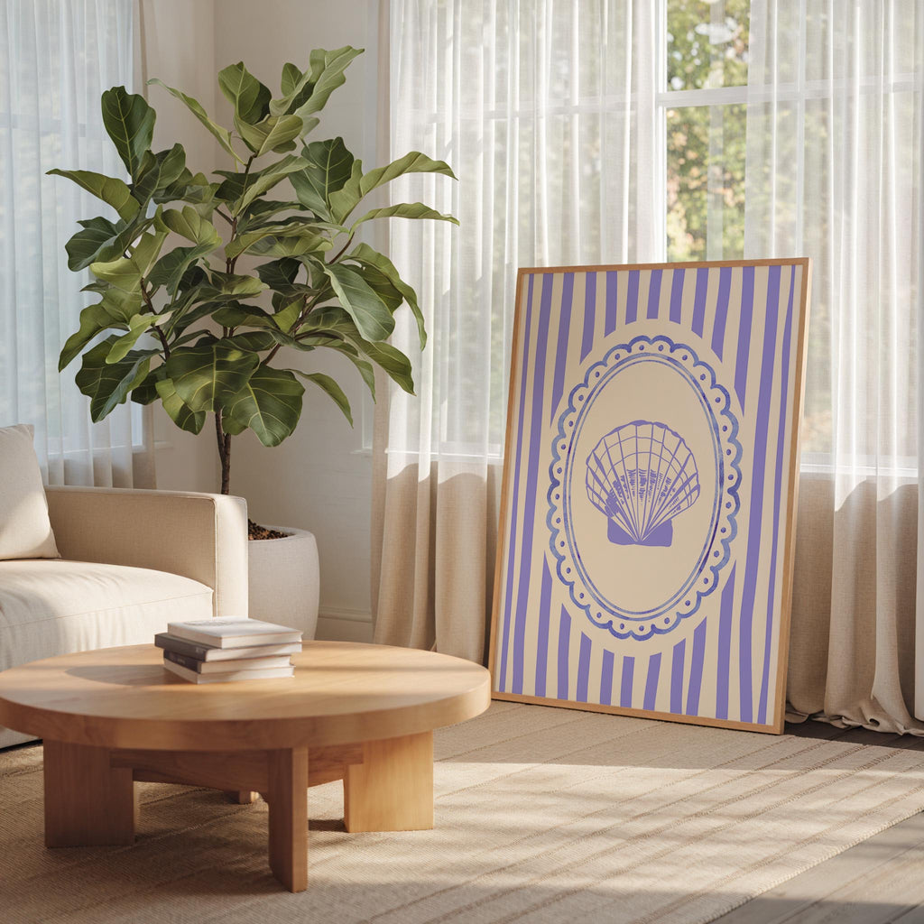 a cozy living room with a large potted plant, a wooden coffee table, and a framed picture with a shell design on the wall.