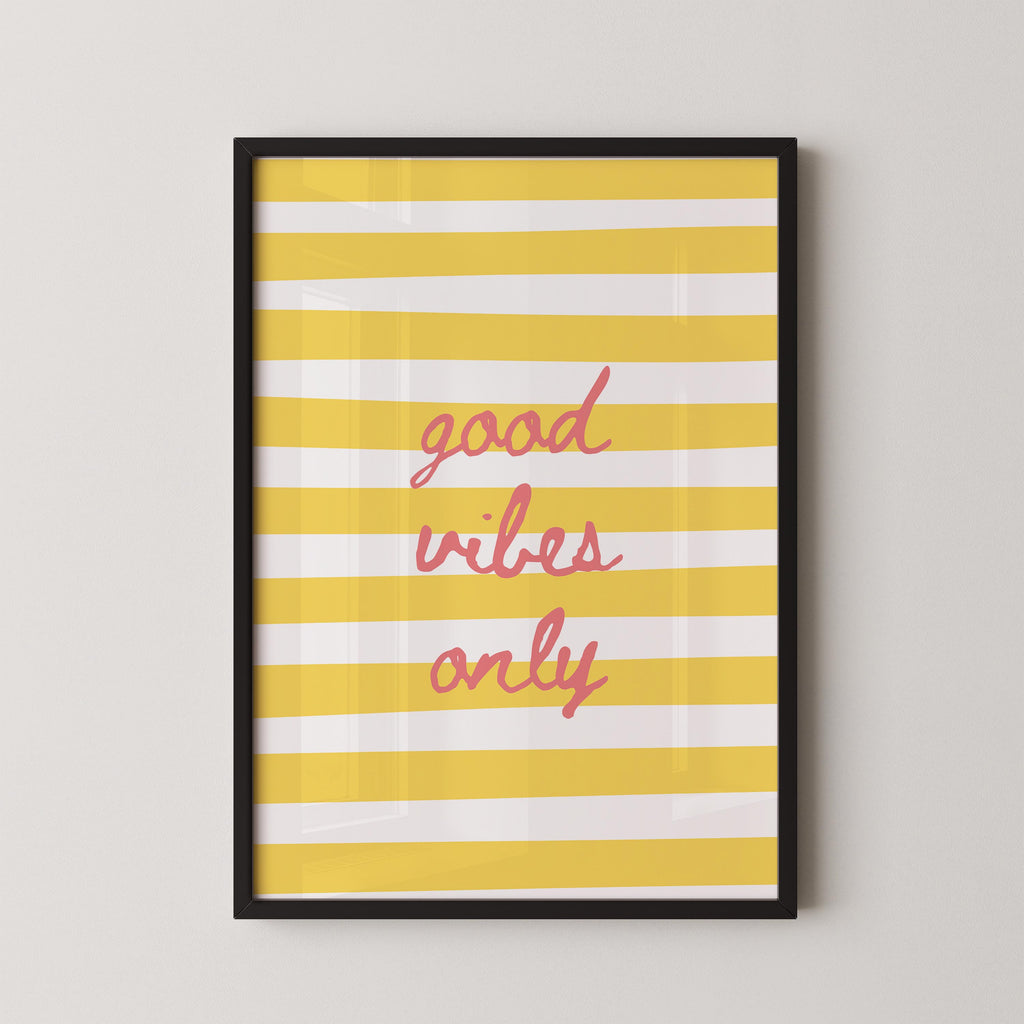 a framed poster with a yellow and white striped background and the text "good vibes only" written in pink cursive font.