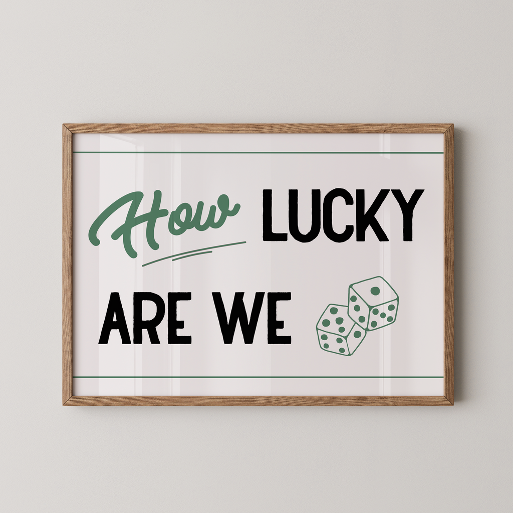 A framed poster with the text "How LUCKY ARE WE" and two dice graphics.